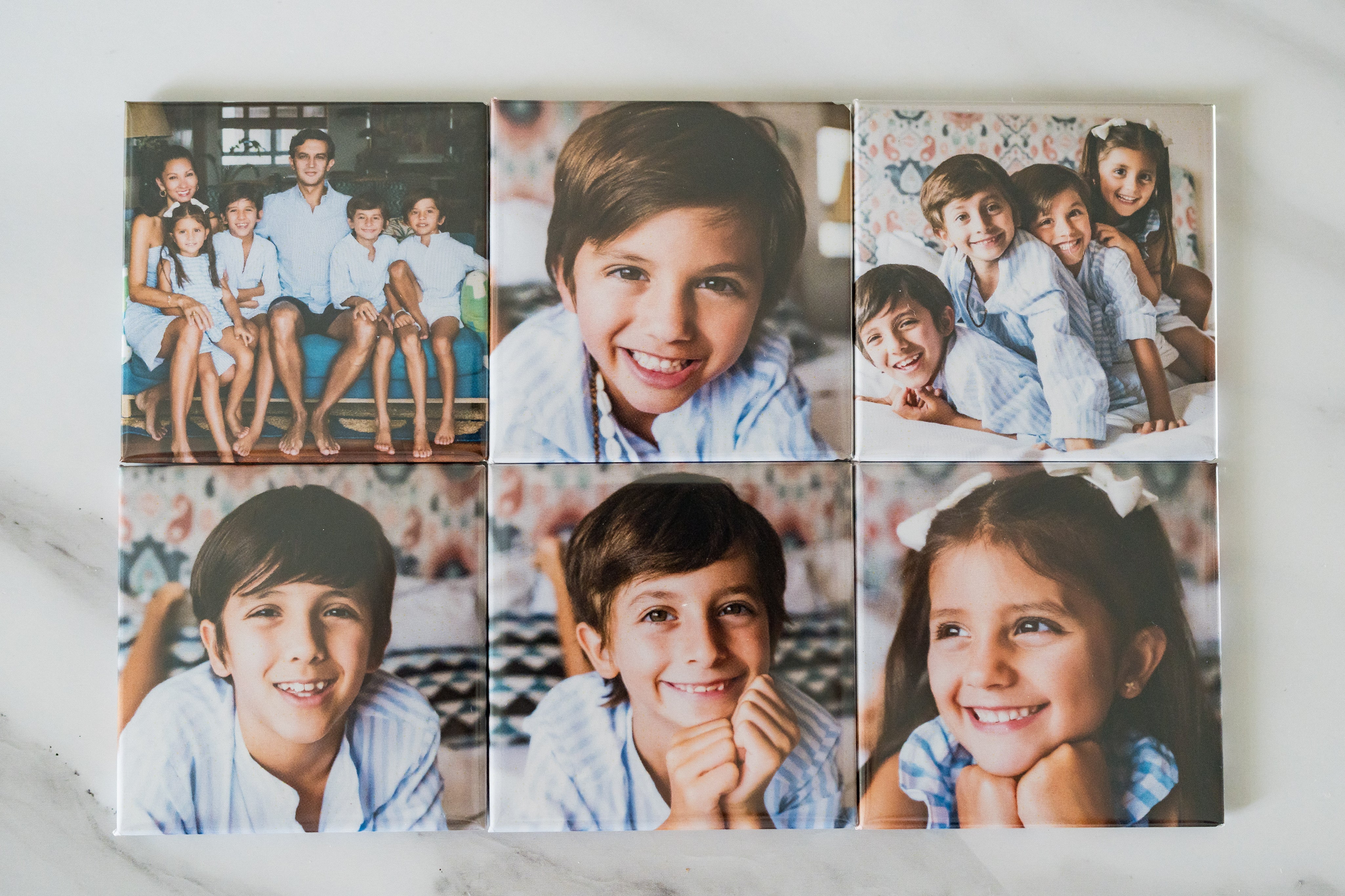 Collage of children's portraits on a white surface
